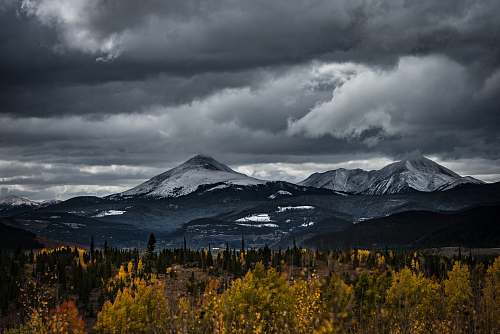 mountain range snow capped mountain under cloudy sky peak